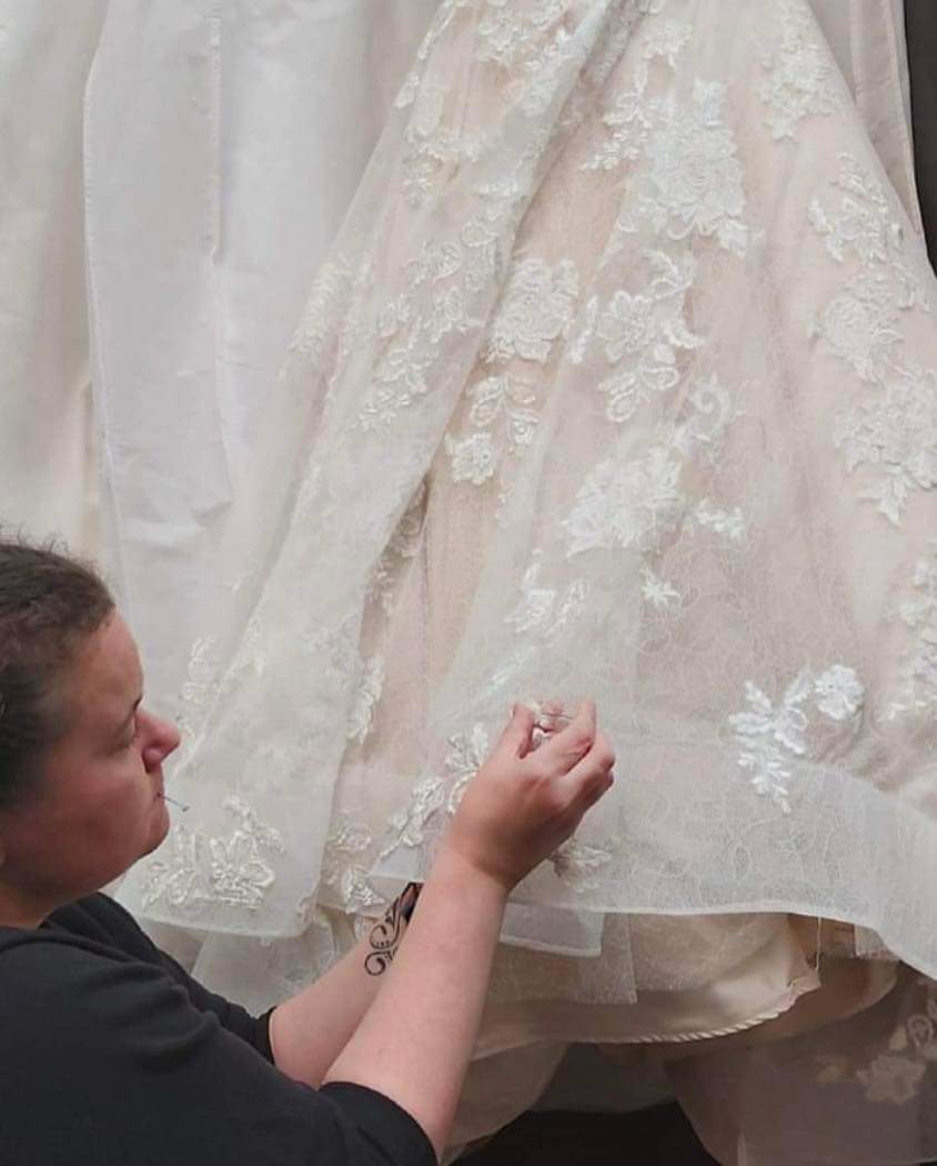 Woman altering wedding dress